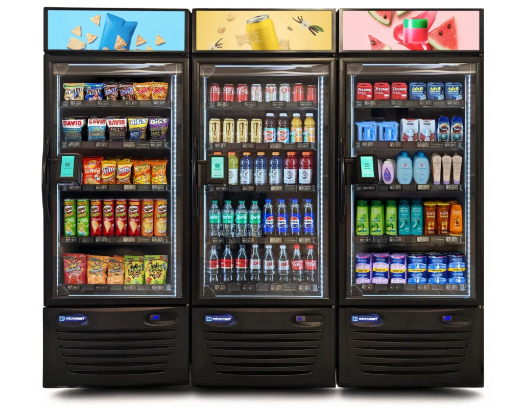 A fully stocked, customized corporate micro-market featuring fresh food, open retail shelving, and AI smart fridges installed in a Denver office breakroom.